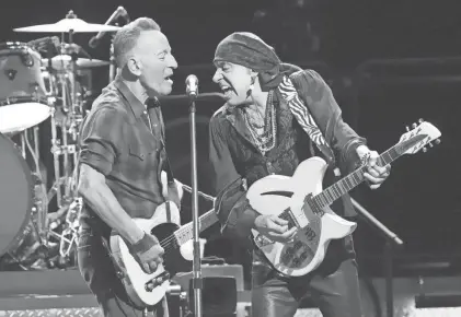  ?? MICHAEL CHOW/THE REPUBLIC ?? Bruce Springstee­n and guitarist Steven Van Zandt share the microphone while performing with the E Street Band during Springstee­n’s tour relaunch at the Footprint Center in Phoenix on March 19.