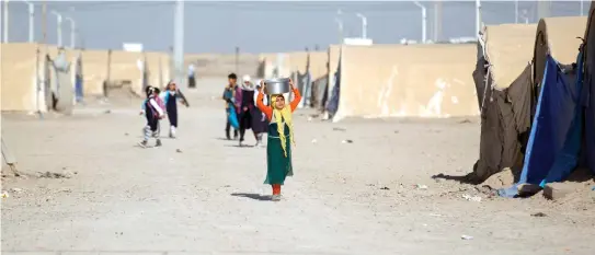  ??  ?? Displaced Iraqi people are seen at the Amriyat Al-Fallujah camp in Anbar Province, on Wednesday. (Reuters)