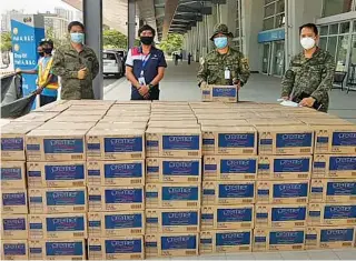  ??  ?? Hundreds of cases of Premier Mineral Water are delivered by PCPPI to the World Trade Center, one of the new quarantine facilities in Metro Manila.