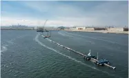  ?? AP PHOTO BY THE OCEAN CLEANUP ?? In this Monday, Aug. 27, photo provided by The Ocean Cleanup, a long floating boom that will be used to corral plastic litter in the Pacific Ocean is assembled in Alameda.