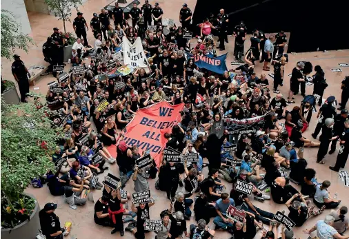  ?? AP ?? Protesters against Supreme Court nominee Brett Kavanaugh sit in the atrium of the Hart Senate Office Building on Capitol Hill in Washington.