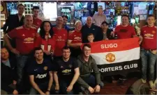  ??  ?? Old Trafford Stadium Announcer Alan Keegan with members of the Sligo Branch of the Manchester United Supporters Club in The Crossbar, Gurteen.