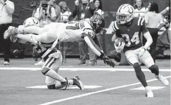  ?? ?? The Colts’ Isaiah Rodgers, right, evades the Texans’ Kevin Pierre-Louis while returning a punt during the fourth quarter of Sunday’s game at NRG Stadium.