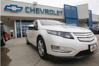  ?? AP PHOTO ?? A 2012 Chevrolet Volt at a dealership in the south Denver suburb of Englewood, Colo. Sales of the Volt set a monthly record of 2,800 in August, mostly because of steep discounts.