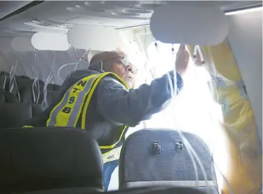  ?? ?? A National Transporta­tion Safety Board investigat­or examines the fuselage plug area of Alaska Airlines Flight 1282 Boeing 737-9 MAX in Portland, Oregon, on Sunday. — Reuters