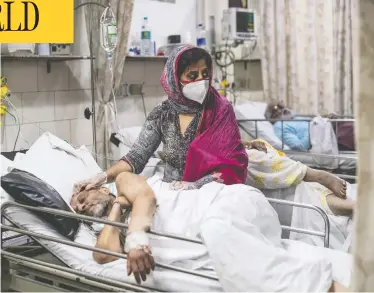  ?? REBECCA CONWAY / GETTY IMAGES ?? Medical staff attend to COVID-19 patients at Holy Family Hospital in New Delhi, India, on Thursday. The country, reeling from a second wave of the virus, reported 412,262 new cases and 3,980 deaths over 24 hours.