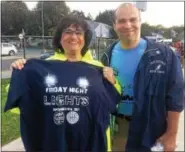  ?? EVAN BRANDT — DIGITAL FIRST MEDIA ?? Pottstown High School Principal Danielle McCoy, with Superinten­dent Stephen Rodriguez, holds one of the soldout commemorat­ive shirts sold for the occasion of the return of the lights.