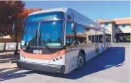  ?? ADOLPHE PIERRE-LOUIS/JOURNAL ?? A new Albuquerqu­e Rapid Transit bus is parked at Alvarado Transporta­tion Center in Downtown Albuquerqu­e on Thursday. It is one of 18 ART buses scheduled to begin full service Jan. 1 on Central Avenue.