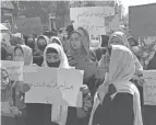  ?? MOHAMMED SHOAIB AMIN/AP ?? Afghan women chant and hold signs of protest in Kabul, Afghanista­n, Saturday.