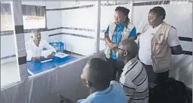  ?? AL-HADJI KUDRA MALIRO/AP ?? Claude Mabowa Sasi, who had lost his mother, a brother and a sister to Ebola, takes his college entrance exam July 20 in an isolation room at a treatment center in Beni, Congo.