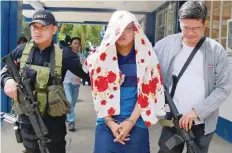  ?? — Reuters ?? Police escort one of the Maute brothers, Mohammad Noaim Maute, alias Abu Jahid, who was arrested at a checkpoint, in Cagayan De Oro city, Philippine­s, on Thursday.
