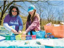  ?? APRIL GAMIZ/THE MORNING CALL ?? PPL volunteers Meg Welker and Emily Dobies show off the various activities for children April 22, 2022, during an Earth Day celebratio­n at Lehigh Valley Zoo.