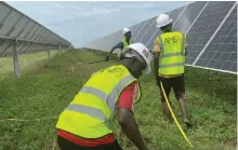  ?? Abu Dhabi Fund for Developmen­t ?? Clockwise from left, pupils in a new school in Blitta; a child uses a blackboard; solar panels in the town; the Sheikh Mohamed bin Zayed Solar Power Plant has added 50MW of power to Togo’s energy supply