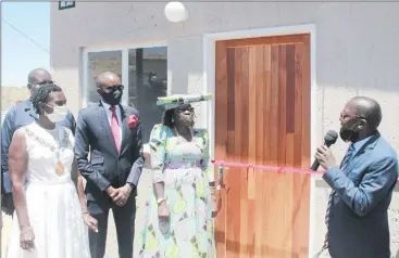  ?? Photo: Emmency Nuukala ?? Housing for all… Minister Erastus Uutoni hands over a completed house to Otjomuise resident Alma Ndjiharine while Windhoek mayor Fransina Kahungu and Sam Shivute look on.