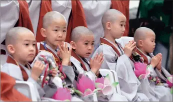  ?? PICTURE: AP ?? Shaven-headed boys put their hands together after a service to celebrate Buddha’s upcoming birthday, at Jogye temple in Seoul, South Korea, yesterday. Nine children entered the temple to experience the life of a monk for two weeks. Buddha was born...