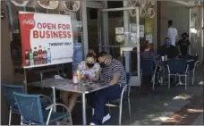  ?? AP PHOTO/MARCIO
JOSE SANCHEZ ?? In this July 18 file photo, Josefina Pacheco, front left, and her husband Norberto wait to have a meal served outside at a restaurant in Burbank, Calif. Gov. Gavin Newsom announced a new, color-coded process Friday, for reopening California businesses amid the coronaviru­s pandemic that is more gradual than the state’s current rules to guard against loosening restrictio­ns too soon.