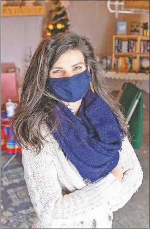  ??  ?? Paxton stands inside her makeshift bookstore that she opened in her garage. (The Des Moines Register/Zach Boyden-Holmes)