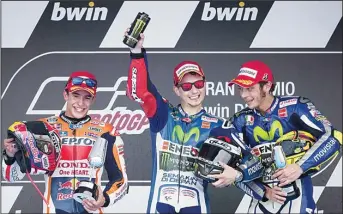  ??  ?? Winner Movistar Yamaha MotoGP’s Spanish rider Jorge Lorenzo (right), second Repsol Honda Team’s Spanish rider Marc Marquez (left), and third Movistar Yamaha MotoGP’s Italian rider Valentino Rossi celebrate on the podium of the MotoGP race of the...