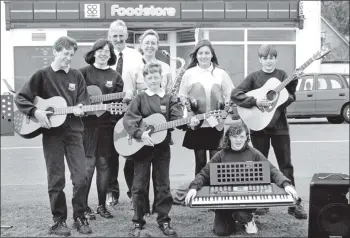  ?? 01_B20twe01 ?? Over the past six months, parents and pupils of Arran High School have collected 31,528 Co-op music vouchers which have been used to purchase musical instrument­s. Pictured outside Lamlash Co-op are Iain Soutter, Robin Smith, Laura Keeney, Richard...