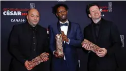  ??  ?? (From left) French producer Toufik Ayadi, French director Ladj Ly and French producer Christophe Barral pose with their trophies during a photocall after they won the Best Film award for “Les Miserables”.