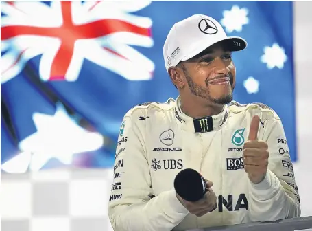  ?? Picture: Getty. ?? Lewis Hamilton celebrates on the podium after his unexpected victory sent him 28 points clear.