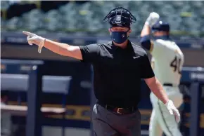  ?? COURTESY OF MILWAUKEE BREWERS ?? Minor-league instructor Charlie Greene has been doing a little bit of everything at summer camp, including calling balls and strikes.