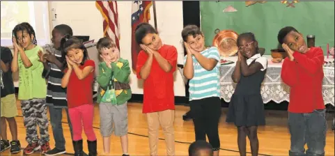  ?? The Sentinel-Record/Richard Rasmussen ?? PATRIMONIO: Kindergart­en students at Langston Aerospace and Environmen­tal Studies Magnet School perform a song together during the school’s second annual Hispanic Heritage Month assembly on Friday.