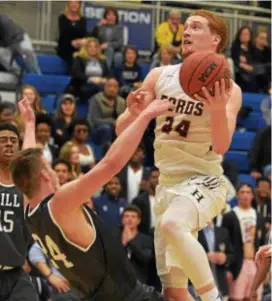  ?? PETE BANNAN — DIGITAL FIRST MEDIA ?? Haverford School’s Christian Ray, right, is called for charging on Hill School’s Nick Alikakos Saturday in the PAISAA final. Alikakos, in a postgrad year after an accomplish­ed career at Episcopal Academy, scored 20 points in a 68-50 win for Hill.