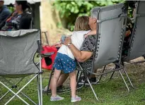  ??  ?? Lauren Jones, 5, gets a hug from her nana after the family home was destroyed in a fire.