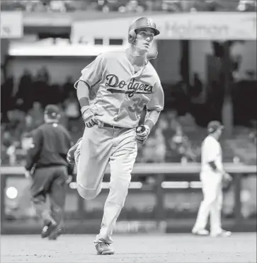  ?? Tannen Maury European Pressphoto Agency ?? CODY BELLINGER CIRCLES the bases after hitting a go-ahead home run in the top of the 12th inning. It was the 12th homer for Bellinger, who was named National League rookie of the month for May.