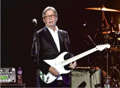  ?? ERIC CLAPTON GARETH CATTERMOLE Getty Images ?? on stage March 3, 2020, in London. His dangerous rhetoric on vaccines can’t be separated from his music.