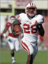  ?? Associated Press ?? Wisconsin’s Montee Ball runs 49 yards for one of his three touchdowns during last Saturday’s game against Indiana, bringing his career total to 77 TDs.