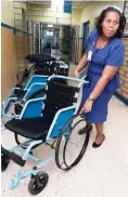  ??  ?? Joan Walker-Nicholson, director of nursing services, Kingston Public Hospital, shows one of the wheelchair­s without its tyres during a tour of the hospital on Wednesday.