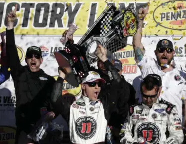  ?? ISAAC BREKKEN — ASSOCIATED PRESS ?? Kevin Harvick hoists the trophy with his team after winning the NASCAR Cup series race March 11 in Las Vegas.