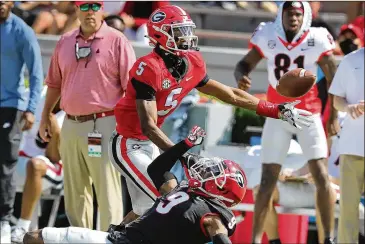  ?? CURTIS COMPTON/CURTIS.COMPTON@AJC.COM ?? Defensive back Ameer Speed (9) breaks up a pass intended for wide receiver Adonai Mitchell during Saturday’s G-day Game. The secondary remains a concern for the Bulldogs.