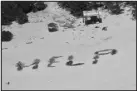  ?? COAST GUARD VIA THE ASSOCIATED PRESS ?? Three stranded mariners spelled “HELP” with palm fronds on Pikelot Atoll, in the Federated States of Micronesia. The three are safe after being stranded for more than a week.