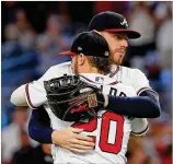  ?? KEVIN C. COX / GETTY IMAGES ?? The Braves’ Josh Donaldson (20) and Freddie Freeman celebrate their 4-2 win over the Washington Nationals at SunTrust Park on Thursday.