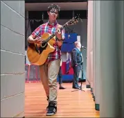  ?? SEAN D. ELLIOT/THE DAY ?? Braiden Sunshine of Old Lyme, a finalist on “The Voice,” warms up backstage Monday as Cutler Middle School principal Peter Bass introduces him before a performanc­e for the students in Groton.