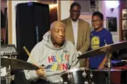  ?? MICHAEL R. SISAK - THE ASSOCIATED PRESS ?? Bill Cosby plays the drums at the LaRose Jazz Club in Philadelph­ia on Monday, Jan. 22, 2018 as his spokesman, Andrew Wyatt, and 11-year-old drummer Mekhi Boone look on. It was his first public performanc­e since his last tour ended amid protests in May 2015. Cosby has denied allegation­s from about 60 women that he drugged and molested them over five decades. He faces an April retrial in the only case to lead to criminal charges.