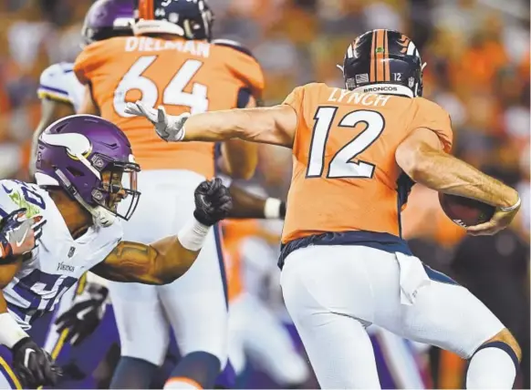  ?? RJ Sangosti, The Denver Post ?? Broncos quarterbac­k Paxton Lynch tries to escape the rush Saturday night. Lynch was 6-for-11 passing for 24 yards and an intercepti­on.