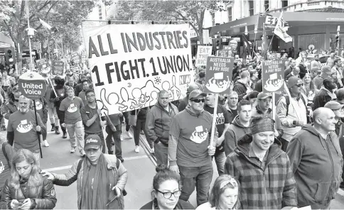  ?? — AFP photo ?? People take part in a march for better work conditions and higher wages in Melbourne.