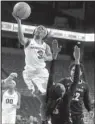  ?? NWA Democrat- Gazette/ MICHAEL WOODS ?? Arkansas guard Malica Monk ( left) shoots around Vanderbilt defender Christa Reed in Thursday night’s game. Monk and the Razorbacks held on to beat the Commodores 59- 56.