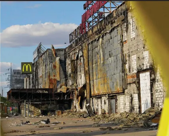  ?? ?? Gutted: A McDonald’s sign is all that’s left to indicate this was once a shopping mall in Kherson