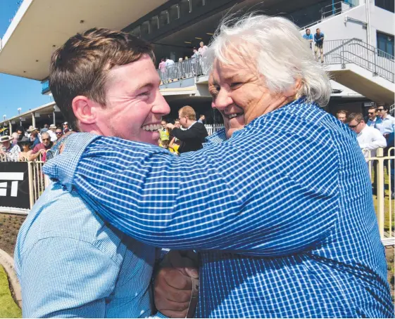  ?? Picture: AAP IMAGE/DARREN ENGLAND ?? Owner Mike Crooks (right) celebrates with trainer Ben Currie after Girl In A Million won at Doomben in September 2017.