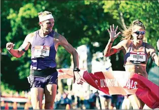  ?? TIMOTHY HEALY / @TRACKTOWNU­SA ?? Nick Christie and Robyn Stevens break the tape at the 2021 Olympic Trials Day 7 race walk. They have been training in Tehachapi.