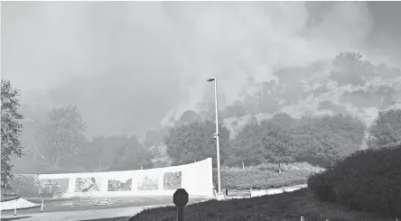  ?? HARRISON HILL/ USA TODAY ?? Smoke fills the entrance of the Getty Center in Los Angeles on Monday. The museum had no plans to evacuate its artworks.