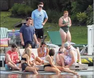  ?? Ned Gerard / Hearst Connecticu­t Media ?? Ten people socialize on a dock behind a home in the Lake Forest neighborho­od of Bridgeport on Friday.