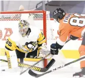  ?? CHRIS SZAGOLA/ AP ?? The Flyers’ Joel Farabee slips the puck past Penguins goaltender Tristan Jarry during the second period Wednesday.