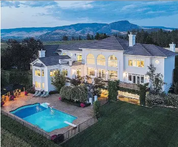  ??  ?? Situated on five and a half hectares, this classicall­y styled, gated Kelowna estate includes five bedrooms, five full bathrooms, a half-bath, and a bonus room. The home was built in 1996 and renovated extensivel­y this year.