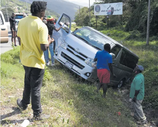  ?? IAN ALLEN/PHOTOGRAPH­ER ?? Passers-by stop to look at a Toyota Hiace bus that spun out of control and crashed into a ditch along the Mandela Highway on Tuesday. The driver rejoiced at having survived the scare along the busy thoroughfa­re. Data from the Road Safety Unit show that up to February 16, there have been 50 fatal crashes, with 55 deaths.